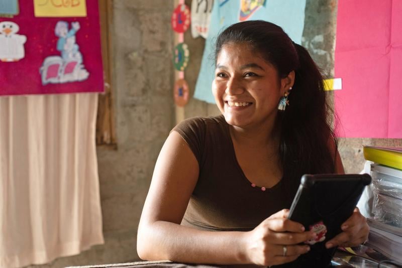 Woman smiling and holding a phone